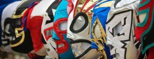 Cartel promocional de Lucha Libre en México con máscaras y colores vibrantes
